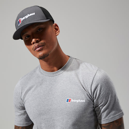 Man wearing a gray Berghaus cap and t-shirt against a gray background