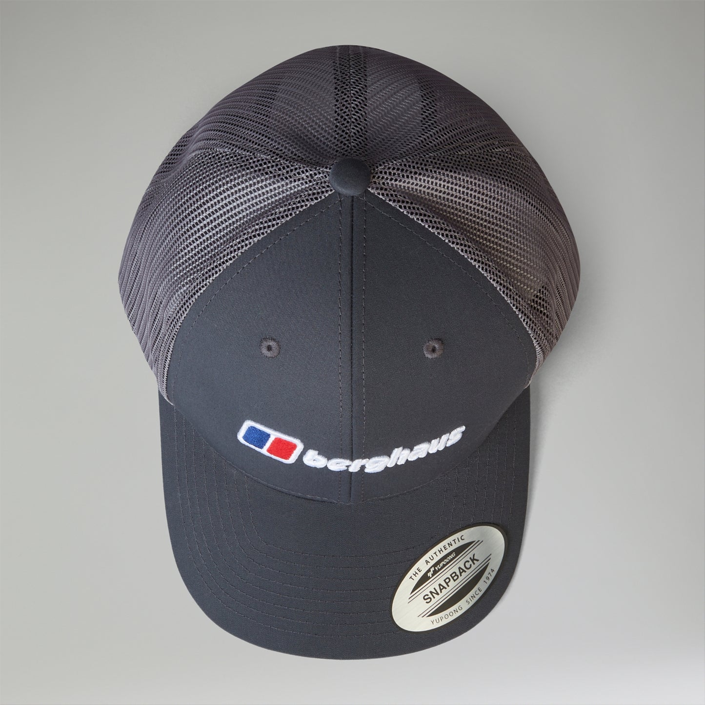 Navy blue cap with mesh back and visible brand logo on a light gray background