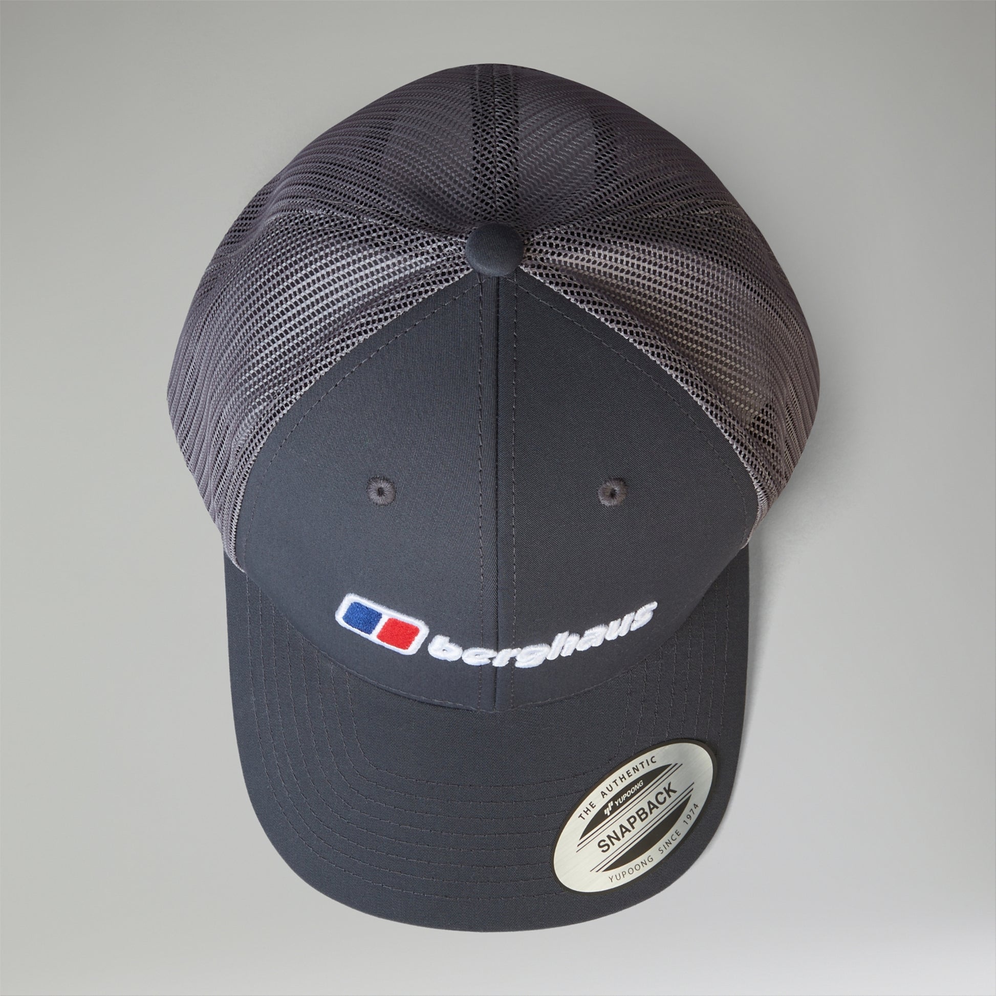 Navy blue cap with mesh back and visible brand logo on a light gray background