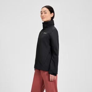 Person wearing a black jacket and red pants on a white background