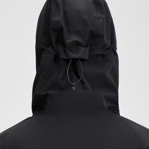 Black hooded jacket worn by a person on a white background