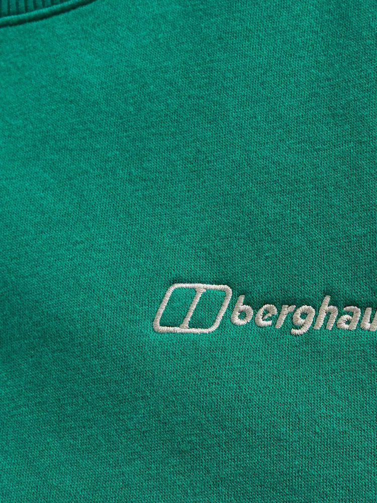 Close-up of a green fabric with a white embroidered Berghaus logo and text.