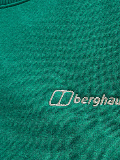 Close-up of a green fabric with a white embroidered Berghaus logo and text.