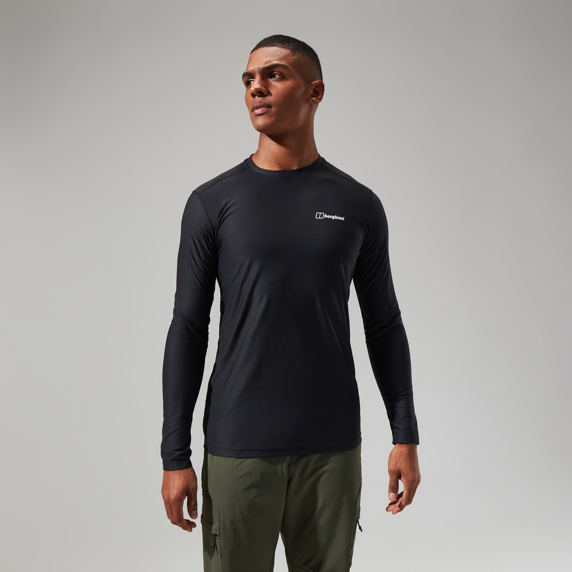 Man wearing a black long-sleeve shirt with a Berghaus logo on a gray background