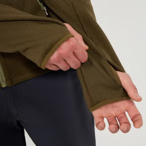 Close-up of a person wearing a green jacket with a white background