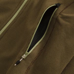 Close-up of a brown textured fabric with a zipper detail