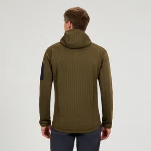 Person wearing a green jacket on a light gray background