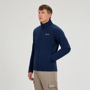 Man wearing a navy blue pullover with a logo on a light gray background