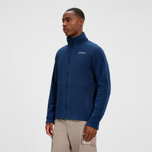 Man wearing a blue jacket with a brand logo on a white background