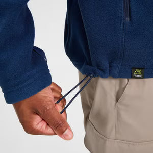Person wearing a blue jacket with a visible brand logo, holding a blue string.