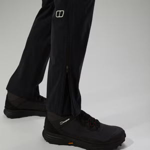 Black pants and shoes with visible brand logos on a light gray background