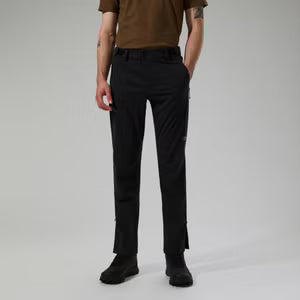 Person wearing black pants on a plain background