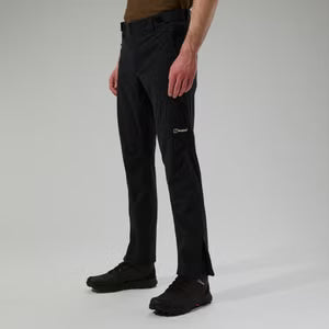 Person wearing black pants with a brand logo on a gray background