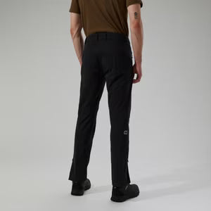 Person wearing black pants on a gray background