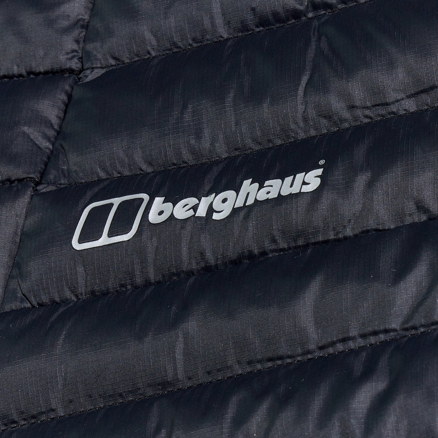 Close-up of a black Berghaus jacket with the brand logo.