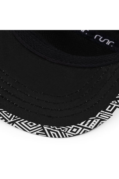 Close-up of black technical running hat brim with geometric panel and small logo