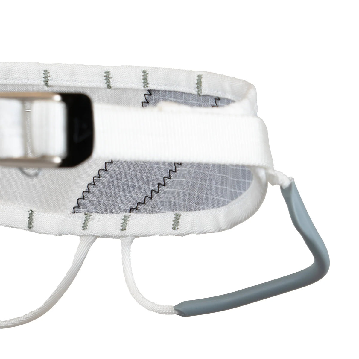 Close-up of white harness leg loop with metal buckle and blue webbing handle