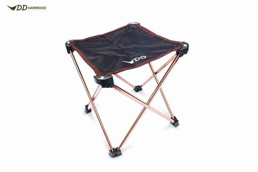 Folding camping stool with black fabric seat and copper-colored metal legs