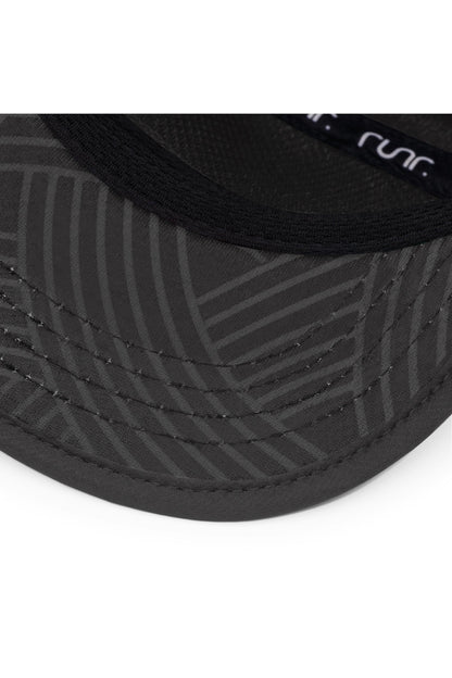 Black technical running hat brim close-up with Runr logo detail and textured fabric