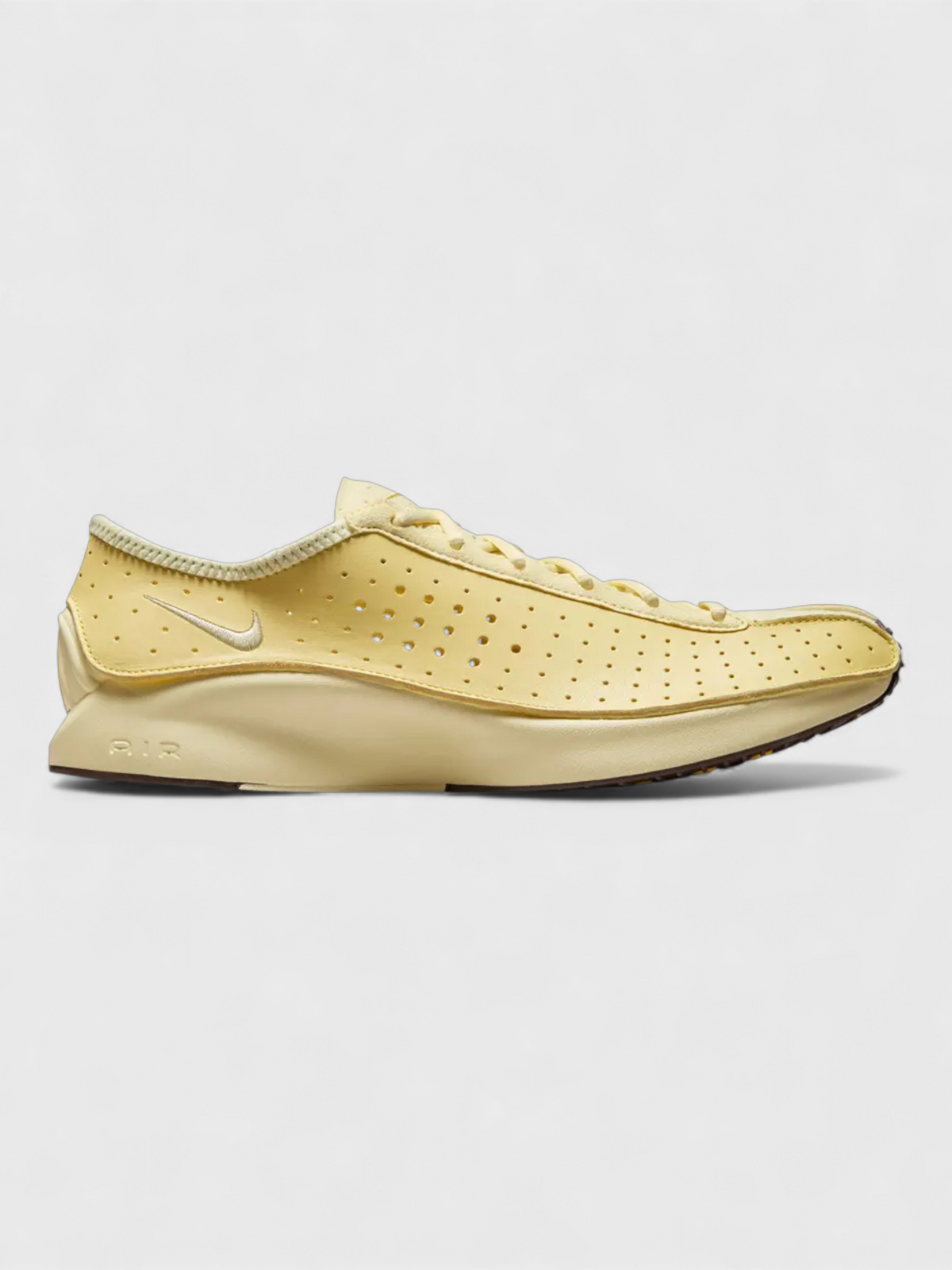 Nike low-top shoes in soft yellow, perforated upper and lace-up.