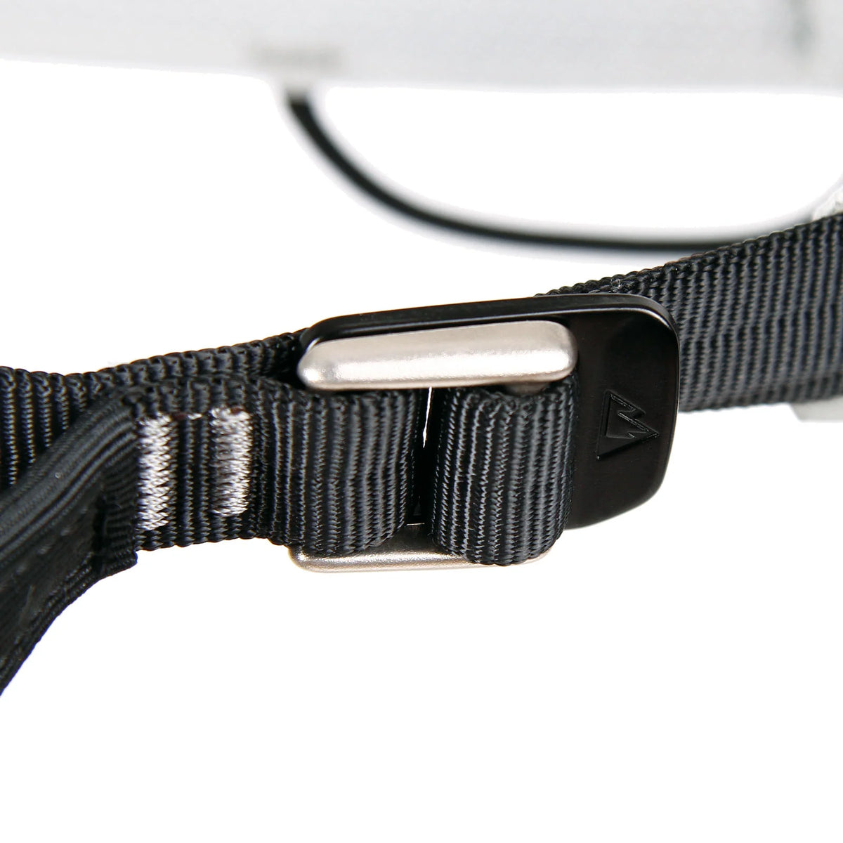 Black buckle on dark webbing strap with metal adjustment bar
