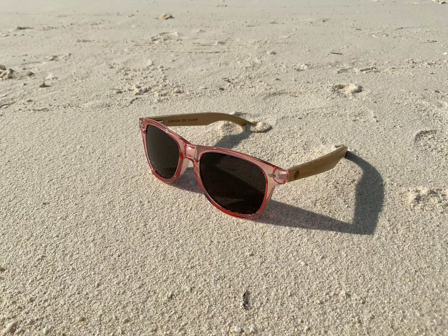 Red cat-eye sunglasses with dark lenses and bamboo-look arms