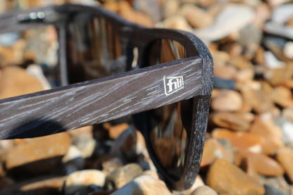 Polarized sunglasses temple and dark lens, 'flii' logo on frame.