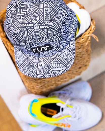 Navy and white geometric technical running hat with front logo patch