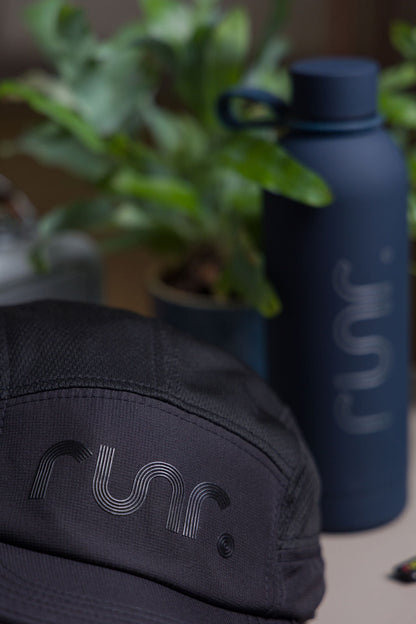 Black running cap side and front close-up with r un. logo and textured fabric
