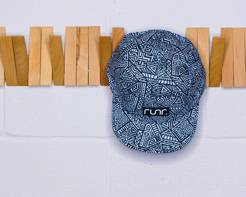 Geometric-pattern technical running hat in navy and white with front logo patch