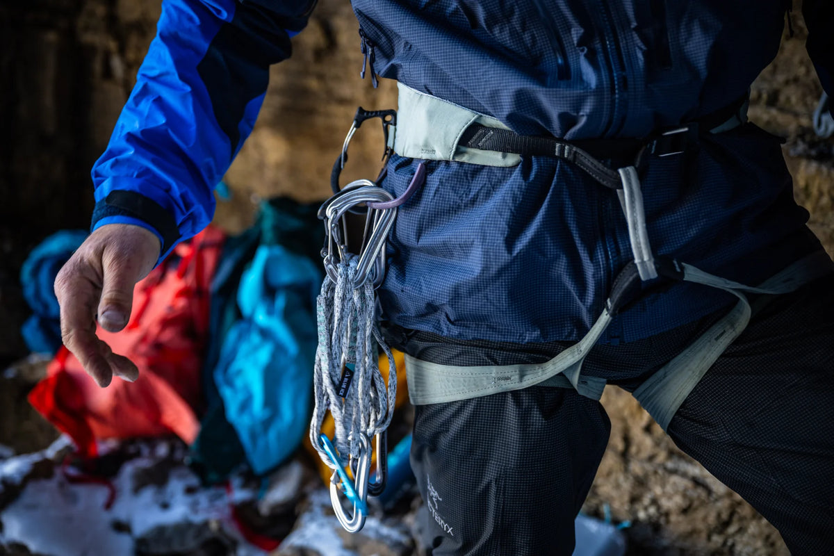 Climbing harness worn on hips with leg loops and hanging gear at the front