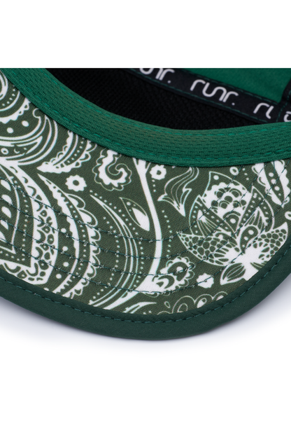 Close-up of green running hat brim with white paisley side panel and dark trim.