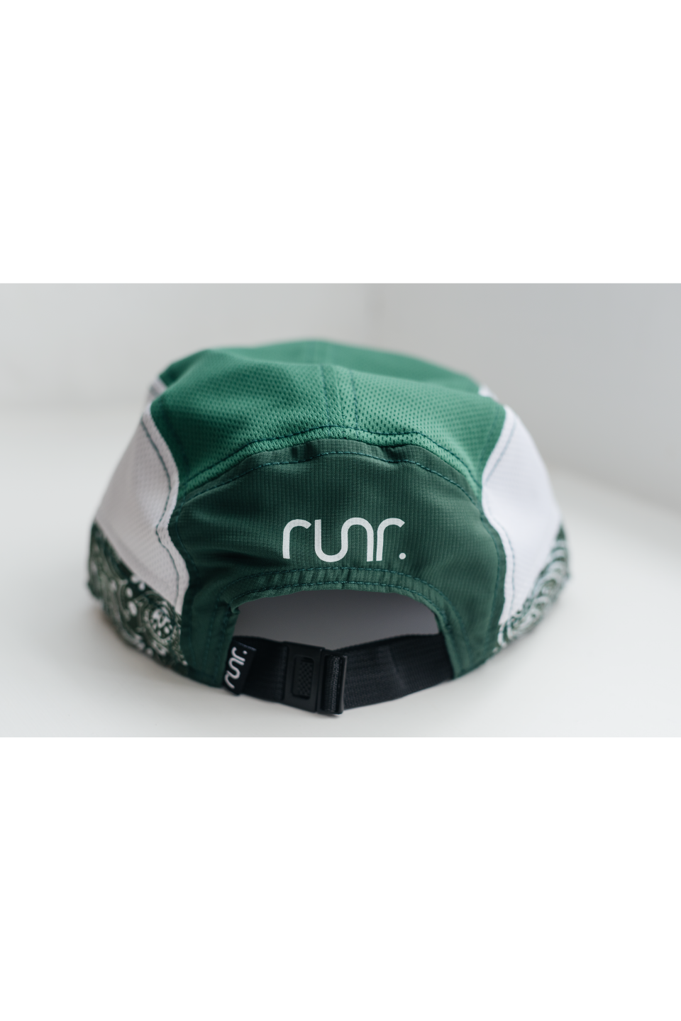 Back view of green technical running hat with black strap and RUNR logo.