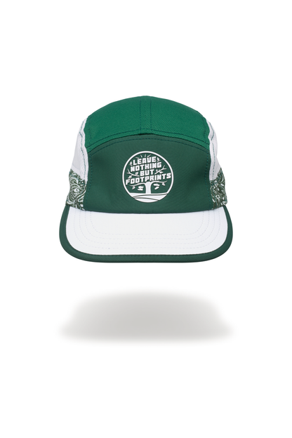 Technical running hat with green top, white brim, and centered footprints emblem