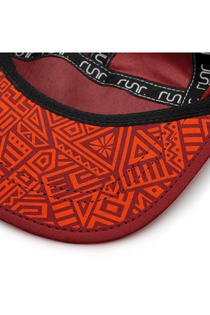 Red cap interior with geometric orange pattern lining and black logo trim