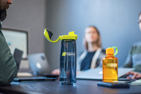 Nalgene 700ml water bottle with dark blue body and lime lock-top cap