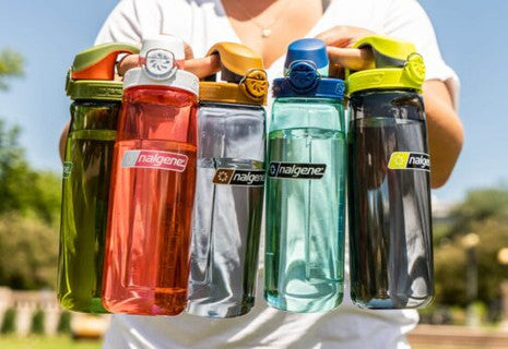 Assorted Nalgene lock-top water bottles in translucent colors, including green and orange
