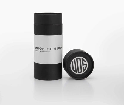 Union of Surf sunglasses case with black-and-white tube and round cap.