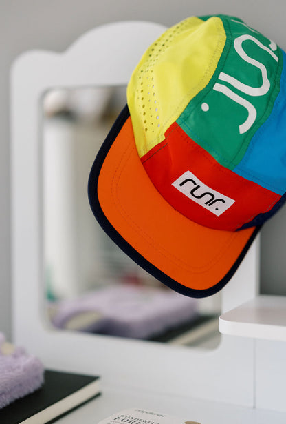 Close-up of multicolor running cap with RUNR label on red panel