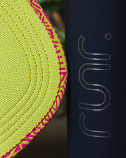 Close-up of hat edge with neon fabric texture and black panel featuring RUN lettering