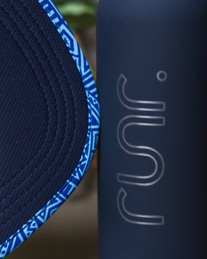 Blue geometric running hat side seam with textured fabric and logo detail
