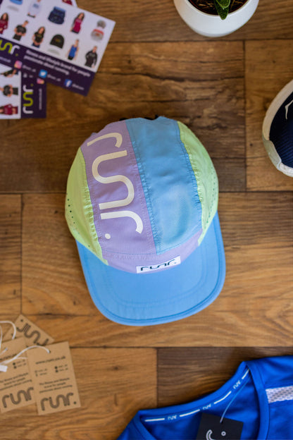 Technical running hat laid flat, light blue brim with purple and mint geometric back panel