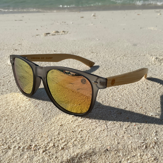 Black cat-eye sunglasses with yellow mirrored lenses and bamboo-look arms