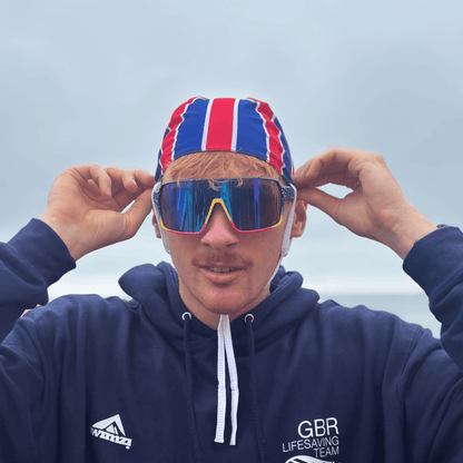 Wraparound sports sunglasses on a person, blue frames and multicolour mirrored lenses
