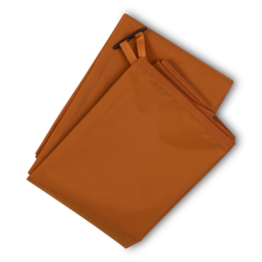 Kelty tent footprint, folded orange-brown fabric with straps and seams visible