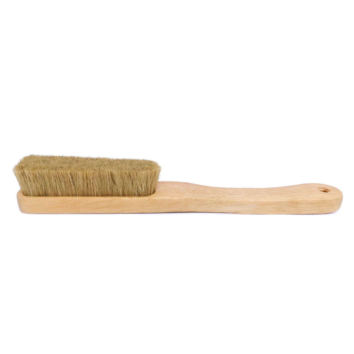 Light wood-handled brush with tan bristles for applying bouldering chalk