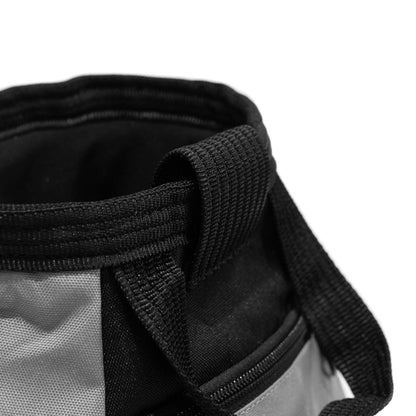 Close-up of grey climbing chalk bucket rim and black woven carry strap