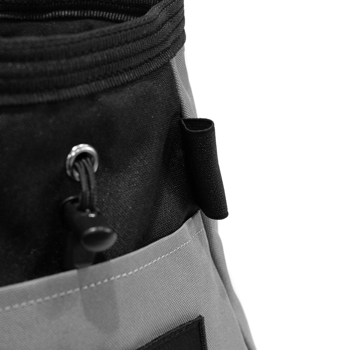 Close-up of grey chalk bucket with black pull cord and metal grommet