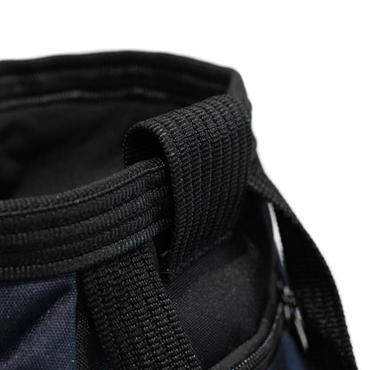 Navy chalk bucket close-up of black webbing carry handle