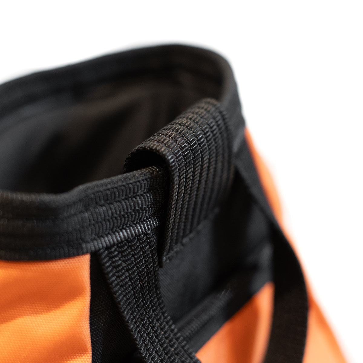 Orange chalk bucket close-up of black handle and open mouth